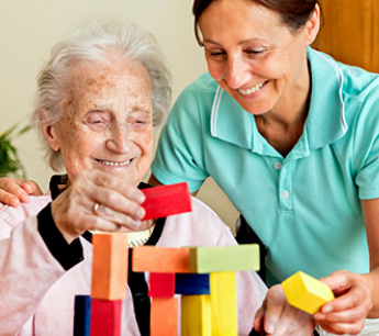 elderly woman in a wheelchair with her caregiver