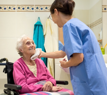 caregiver wrapping elderly man's arm